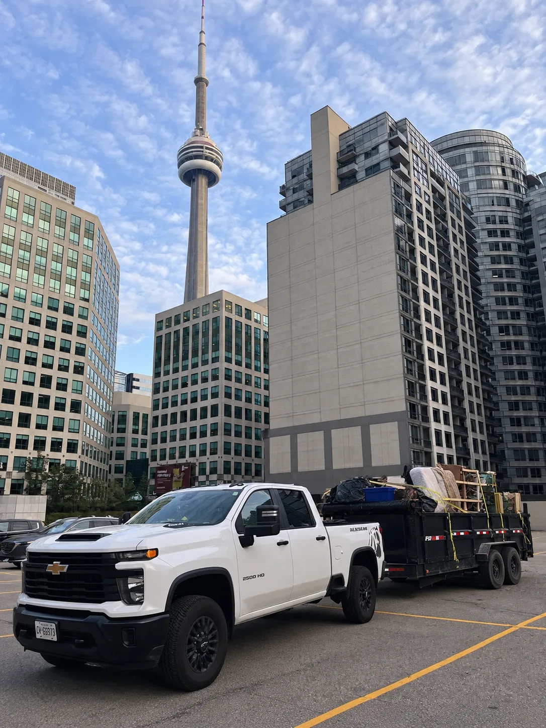 A truck and loaded trailer used for junk removal